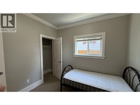 Burnaby apartment for rent - A bedroom with a bed, dresser, and window.