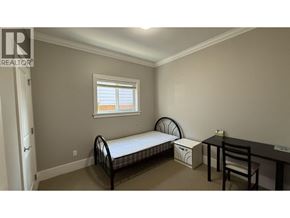 Burnaby apartment for rent - A bedroom with a bed, desk, and chair.