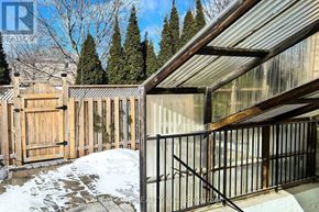 Richmond Hill (Observatory) apartment for rent - A snowy backyard with a wooden fence and a metal gate.