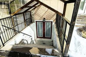 Richmond Hill (Observatory) apartment for rent - A small brown door is on the side of a building.
