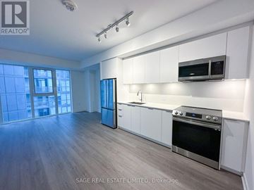 Toronto (Waterfront Communities) condo for rent - A well-lit kitchen with white cabinets and stainless steel appliances.