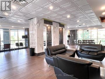 Toronto (Bendale) condo for rent - A living room with black leather sofas and a wooden floor.