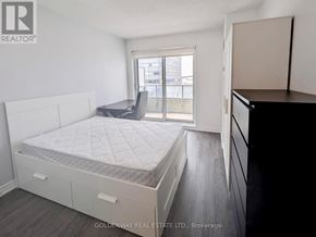 Toronto (Bendale) condo for rent - A bedroom with a large bed and a balcony.