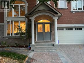 Markham (Berczy) apartment for rent - A house with a front porch and a garage door.