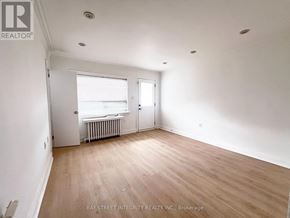 Toronto (Briar Hill-Belgravia) apartment for rent - A room with a window and a door is empty and waiting to be furnished.