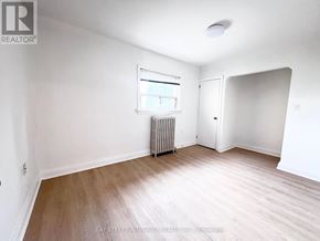 Toronto (Briar Hill-Belgravia) apartment for rent - A room with a window and a radiator on the wall.