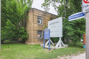 Toronto apartment for rent - A sign for Elderwood Dr stands in front of a brick building.