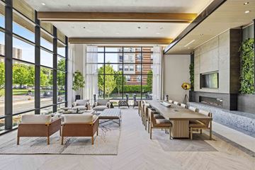 West New York apartment for rent - A modern living room with a long table and chairs.