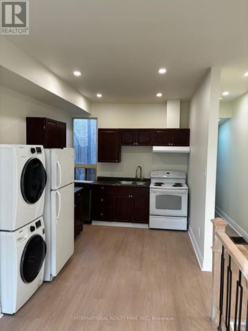 Toronto (Moss Park) triplex for rent - A kitchen with white appliances and wooden floors.