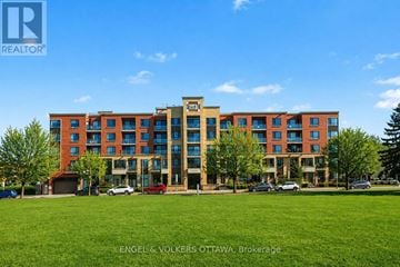 Ottawa condo for rent - A large multi-story building with a grassy area in front.