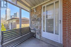 Toronto (St. Andrew-Windfields) apartment for rent - A bench is on a porch with a view of a city skyline.