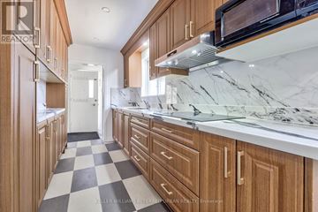 Toronto (St. Andrew-Windfields) apartment for rent - A kitchen with wooden cabinets and a checkered floor.
