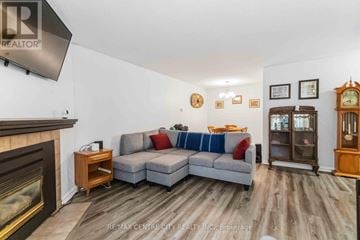 London East (East L) condo for rent - A living room with a grey sofa and a fireplace.