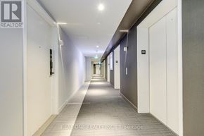 Mississauga (City Centre) condo for rent - A long hallway with doors on both sides and a light on the ceiling.