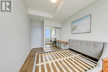 Mississauga (City Centre) condo for rent - A living room with a grey couch and a painting on the wall.