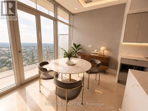 Mississauga (City Centre) condo for rent - A dining room with a table and chairs with a view of the city.