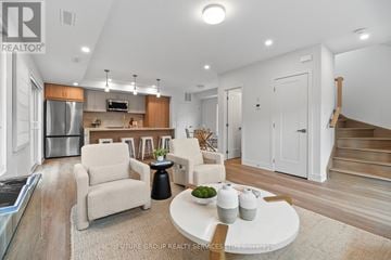 Toronto (Islington-City Centre West) apartment for rent - A modern living room with a white sofa and a glass table.