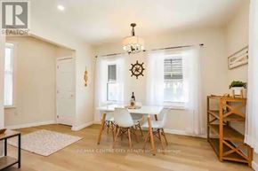 Central Elgin (Port Stanley) condo for rent - A dining room with a table set for two and a chandelier hanging from the ceiling.