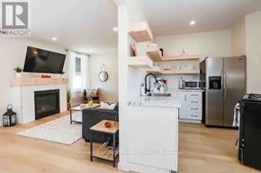 Central Elgin (Port Stanley) condo for rent - A modern kitchen with a fireplace and a TV above it.