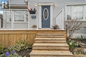 Niagara Falls (Church's Lane) apartment for rent - A house with a blue front door and wooden steps leading up to it.