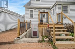 Niagara Falls (Church's Lane) apartment for rent - A house with a wooden staircase leading to a red door.