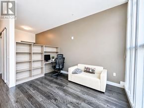 Waterloo condo for rent - A room with a white couch, a black chair, and a desk with a computer.