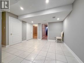 Markham (Middlefield) apartment for rent - A spacious room with white tile flooring and a white chair.