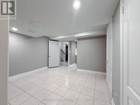 Markham (Middlefield) apartment for rent - A spacious room with white tile flooring and a white door.