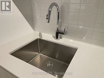 Toronto (Stonegate-Queensway) condo for rent - A modern kitchen sink with a chrome faucet.