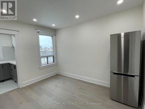 Toronto (Danforth) apartment for rent - A room with a window and a refrigerator.