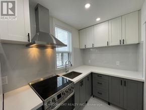Toronto (Danforth) apartment for rent - A modern kitchen with a stove top oven and a range hood.