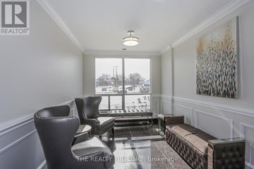 London South (South D) condo for rent - A living room with a large window and a painting on the wall.