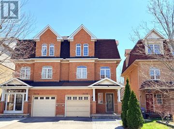 Mississauga (Churchill Meadows) apartment for rent - A large red brick house with a white garage door.
