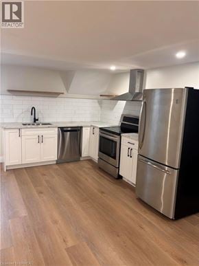 Brantford apartment for rent - A kitchen with wooden floors and stainless steel appliances.