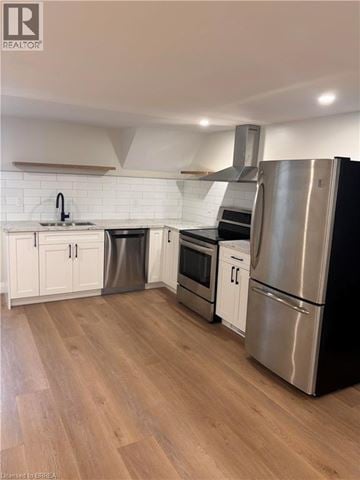 Brantford apartment for rent - A kitchen with wooden floors and stainless steel appliances.