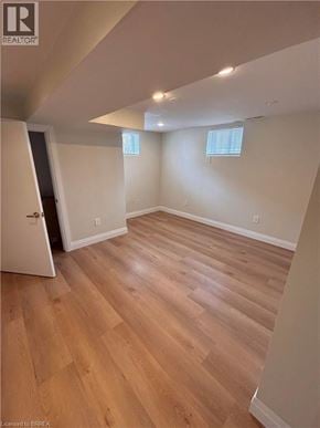 Brantford apartment for rent - A room with wooden flooring and a doorway leading to another room.
