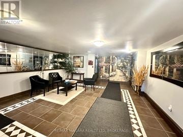 St. Catharines (Glendale/Glenridge) condo for rent - A living room with a black sofa and a coffee table.