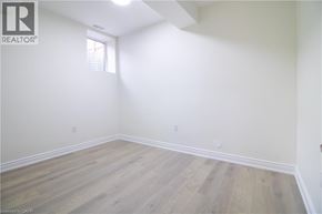Kitchener apartment for rent - A room with wooden flooring and white walls.