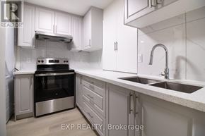 Kitchener apartment for rent - A modern kitchen with white cabinets and stainless steel appliances.