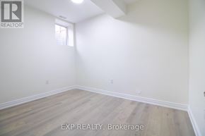 Kitchener apartment for rent - A room with wooden flooring and white walls.