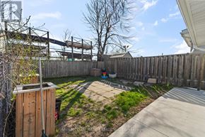 Hamilton (Industrial Sector) apartment for rent - A backyard with a wooden fence and a trash can.