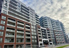 Clarington (Bowmanville) condo for rent - A modern apartment building with the name HOMELIFE/MIRACLE REALTY LTD. Brokerage on the facade.