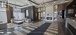 Markham (Wismer) condo for rent - A modern living room with a fireplace and a black and white rug.