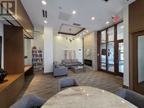 Markham (Wismer) condo for rent - A living room with a fireplace and a couch.