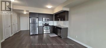 Markham (Wismer) condo for rent - A kitchen with a refrigerator, oven, and sink.