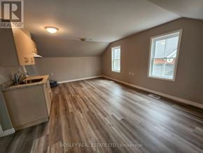 Markham (Wismer) apartment for rent - A room with wooden flooring and a window with a view of a house across the street.
