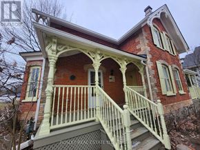 Markham (Wismer) apartment for rent - A red brick house with a white porch and a sign that says Rosley Real Estate.