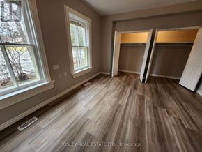Markham (Wismer) apartment for rent - A room with wooden flooring and a window showing trees outside.