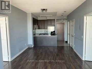 Mississauga (City Centre) condo for rent - A spacious kitchen with dark wood floors and white walls.
