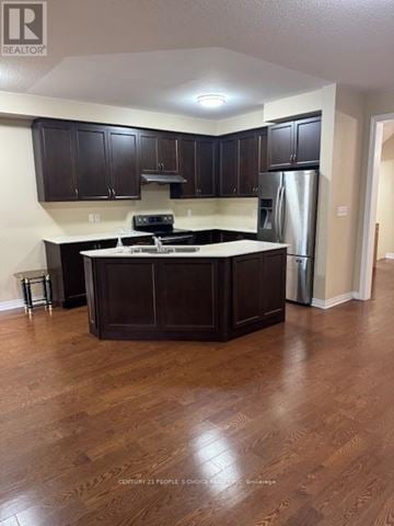 Brampton (Northwest Brampton) townhouse for rent - A kitchen with dark wood cabinets and a white countertop.